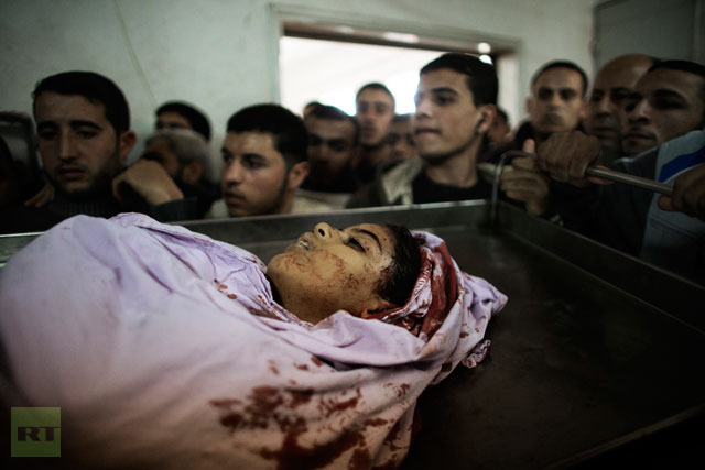 The body of Tasneem al-Nahal, 13, lies in the morgue of the al-Shifa hospital in Gaza City after she was killed by an Israeli airstrike in Shati refugee camp.(AFP Photo / Marco Longari)